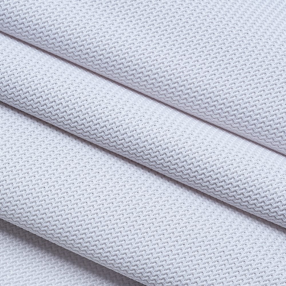Overlapping folds of white golf screen material showing its textured surface